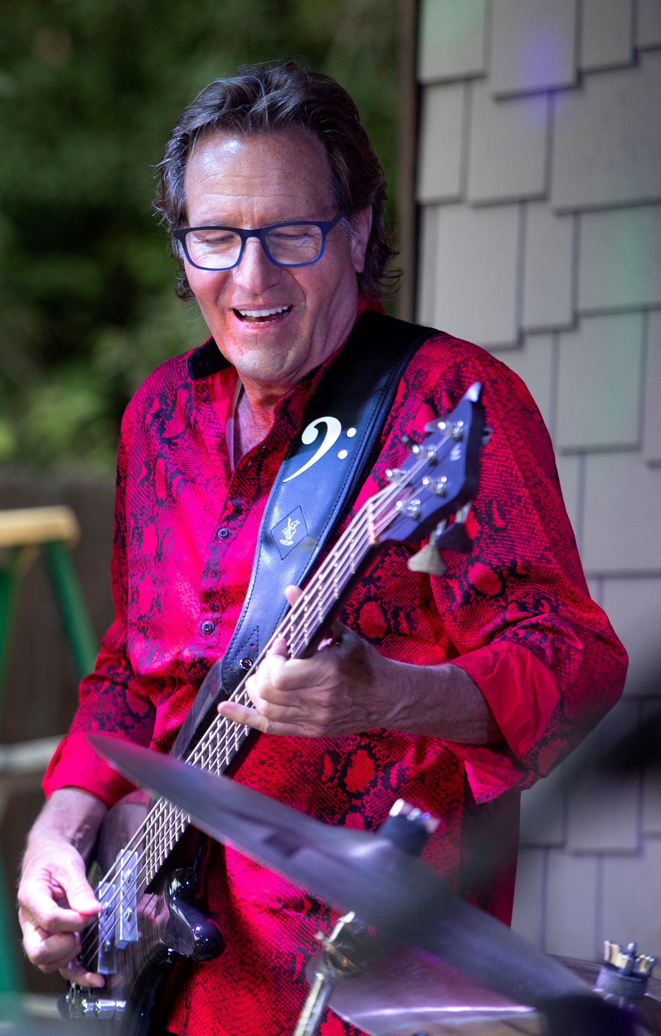 SideKarz bassist performing live in red snakeskin shirt