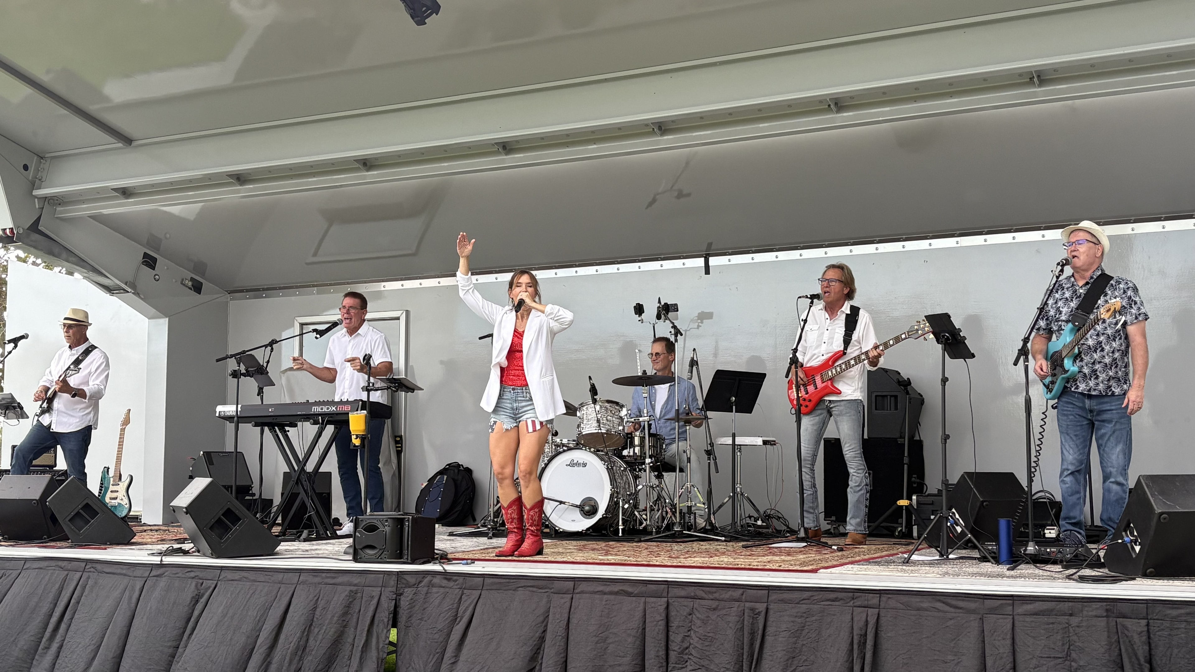 The SideKarz full band performing on outdoor stage