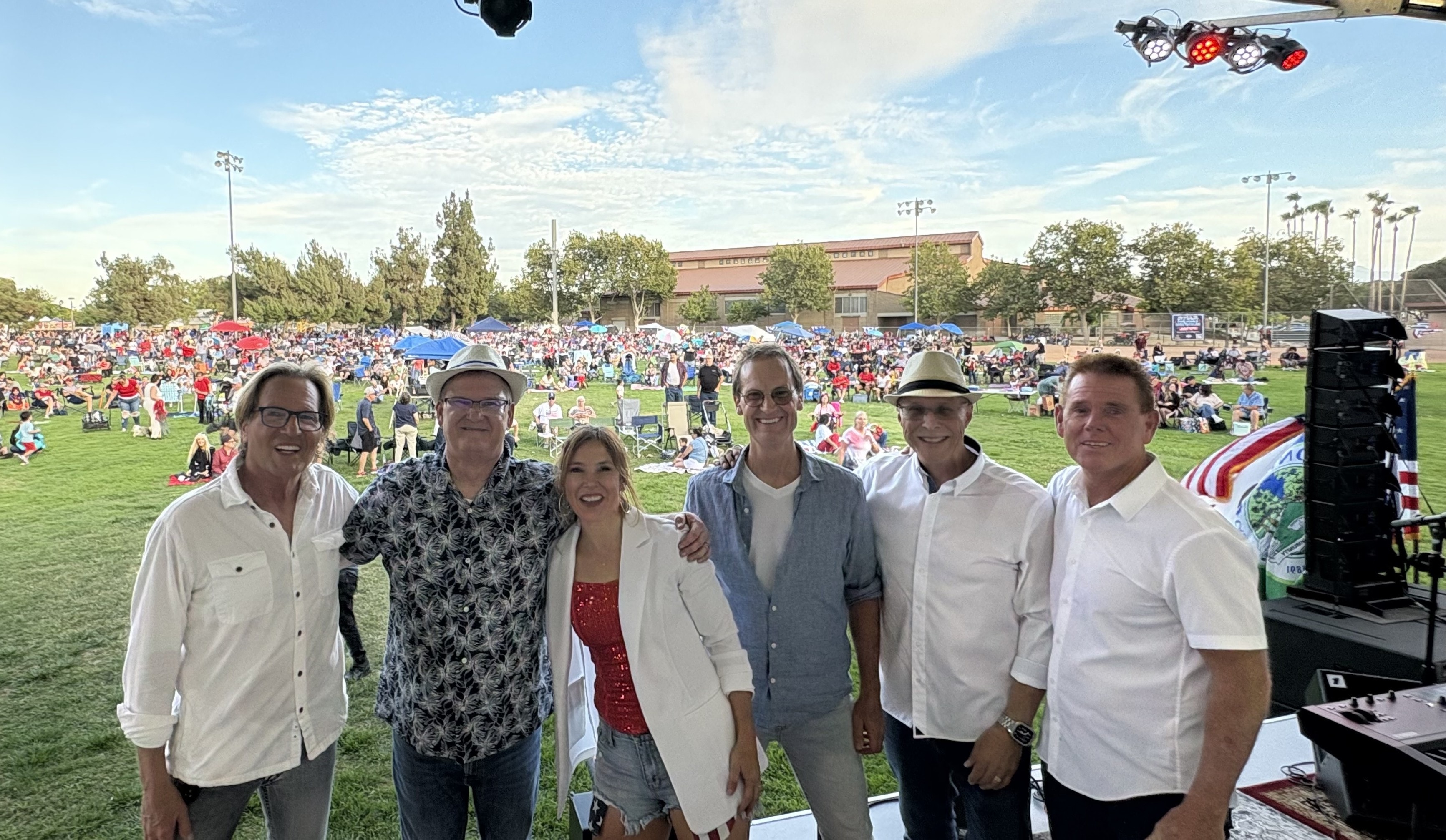 The SideKarz band with large crowd at outdoor event