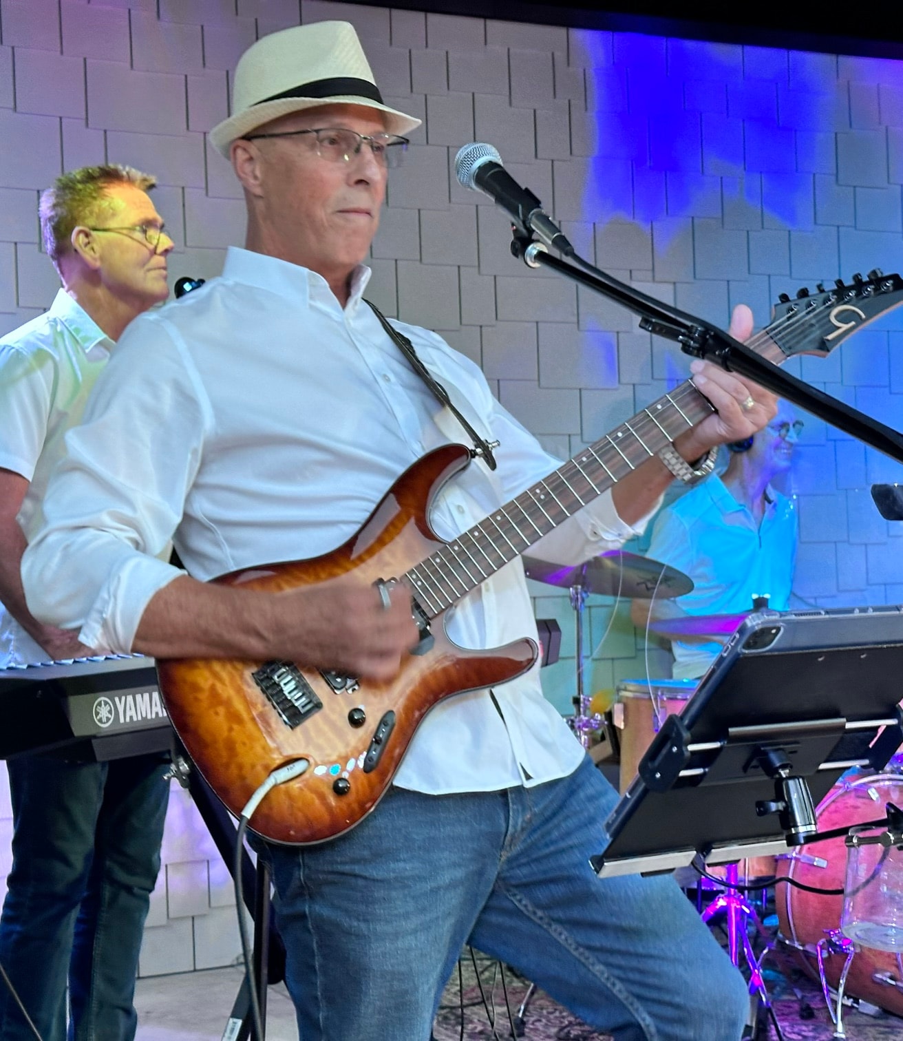 SideKarz guitarist performing with band at indoor venue