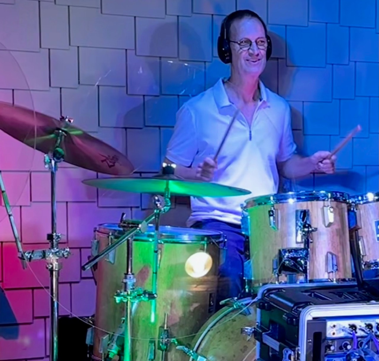 SideKarz drummer performing under colorful stage lights